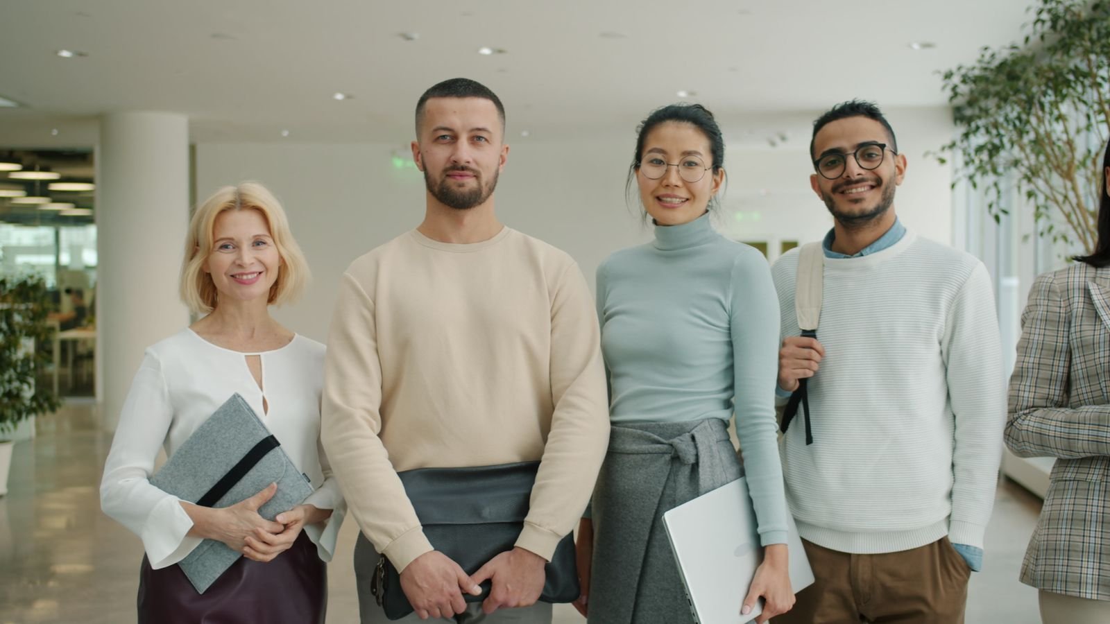 Team of professionals standing in a bright modern office